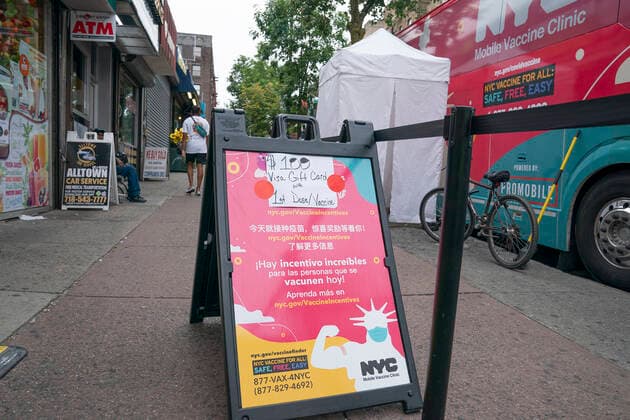 Mobile vaccination pop-up site in the Bronx Mobile vaccination pop-up site set up in the Bronx for COVID-19 vaccine available to passerby people at no cost with prepaid VISA $100 card as insensitive. City administration set up one hundred dollar insensitivity to get more people to get vaccinated amid surge of Delta variant and rise in the number of infections. The site is set by NNYC Health and Hospitals system and will remain for 3 days. They will retrun back for second dose jab on the same location in three weeks. New York New York United States Corner of West 231st street and Copyright: LevxRadin