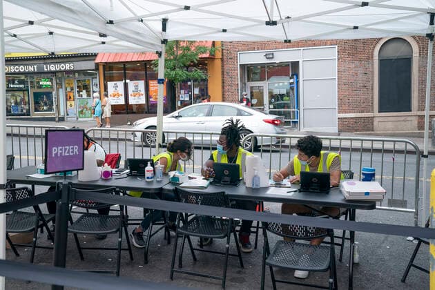 Mobile vaccination pop-up site in the Bronx Mobile vaccination pop-up site set up in the Bronx for COVID-19 vaccine available to passerby people at no cost with prepaid VISA $100 card as insensitive. City administration set up one hundred dollar insensitivity to get more people to get vaccinated amid surge of Delta variant and rise in the number of infections. The site is set by NNYC Health and Hospitals system and will remain for 3 days. They will retrun back for second dose jab on the same location in three weeks. New York New York United States Corner of West 231st street and Copyright: LevxRadin
