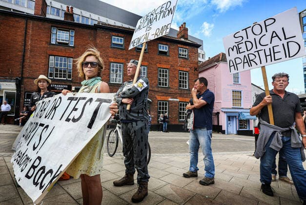 August 10, 2021, Norwich, United Kingdom: Protesters hold a banner and placards during the demonstration..Anti vax-passport protesters visit Norwich to highlight the discrimination they believe is taking place at The Murderers pub. The landlord Phil Cutter has introduced a new no jab, no entry rule that he says protects both his staff and customers. Norwich United Kingdom - ZUMAs197 20210810_zaa_s197_284 Copyright: xMartinxPopex