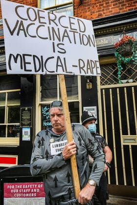 August 10, 2021, Norwich, United Kingdom: Activist Jeff Wyatt holds a placard during the demonstration..Anti vax-passport protesters visit Norwich to highlight the discrimination they believe is taking place at The Murderers pub. The landlord Phil Cutter has introduced a new no jab, no entry rule that he says protects both his staff and customers. Norwich United Kingdom - ZUMAs197 20210810_zaa_s197_290 Copyright: xMartinxPopex
