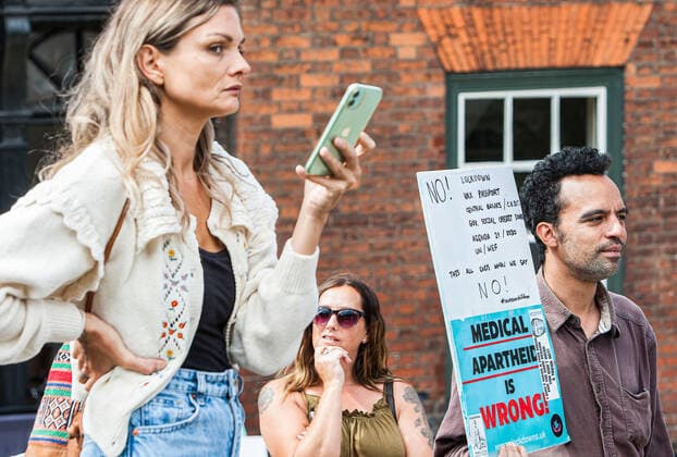 August 10, 2021, Norwich, United Kingdom: A protester holds an anti medical apartheid sign during the demonstration..Anti vax-passport protesters visit Norwich to highlight the discrimination they believe is taking place at The Murderers pub. The landlord Phil Cutter has introduced a new no jab, no entry rule that he says protects both his staff and customers. Norwich United Kingdom - ZUMAs197 20210810_zaa_s197_299 Copyright: xMartinxPopex
