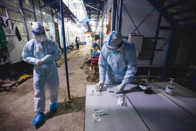 August 12, 2021, Bangkok, Thailand: Zendai volunteers wearing Personal Protective Equipment ( PPE) suits check antigen tests at construction workers camp in Laksi..Covid-19 check-up in construction workers camp in Bangkok. Bangkok Thailand - ZUMAs197 20210812_zaa_s197_055 Copyright: xVaruthxPongsapipattx
