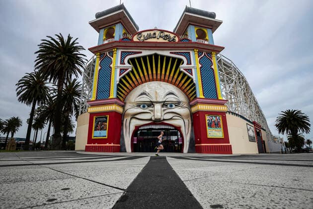 VICTORIA CORONAVIRUS COVID19, A man is seen exercising past Luna Park in St Kilda, Melbourne, Monday, August 16, 2021. Melbourne s lockdown has been extended to at least August 19 to contain a growing outbreak of the Delta variant of COVID-19. ( NO ARCHIVING, EDITORIAL USE ONLY, NO USE IN BOOKS WITHOUT CONSENT MELBOURNE VIC AUSTRALIA  Copyright: xDANIELxPOCKETTx 20210816001567246767
