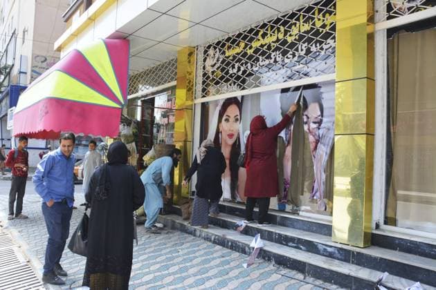 Frauen unter dem Taliban Regime in Afghanistan Taliban insurgents enter Kabul Workers at a beauty salon strip large photos of women off the wall in Kabul on Aug. 15, 2021, following news that the Taliban swept into the Afghan capital.  A14AA0000757912P