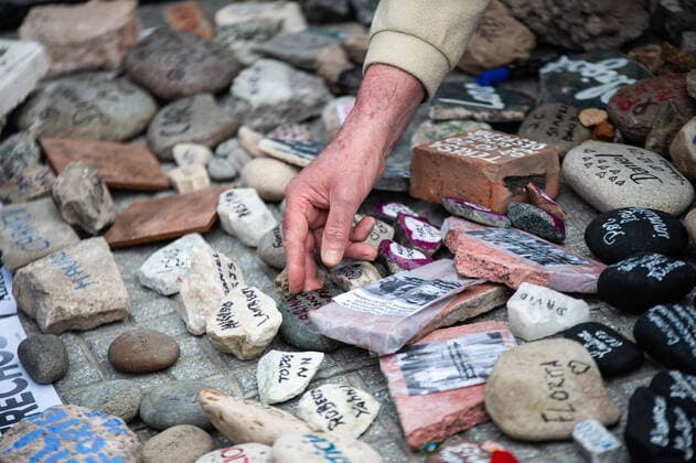 Coronavirus in Argentinien, Demonstration in Buenos Aires August 16, 2021, Buenos Aires, Argentina: A man leaves a stone on the floor with the name of a family member who died due to the coronavirus..March of the stones, a tribute to the victims of Covid-19 and repudiation of the government. The call seeks to represent with a rock each one of the deceased by coronavirus and expose it in front of the central government buildings, in repudiation of the management of the pandemic in Buenos Aires, Argentina. Buenos Aires Argentina - ZUMAs197 20210816_zaa_s197_135 Copyright: xManuelxCortinax