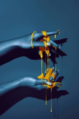 Creative Highlights Symbolbilder Crop unrecognizable woman showing hand with manicure and bright paint fluids in ultraviolet light on blue background, Model released AdrianSava_Hands_26.jpg Copyright: xAdrianxSavax MR