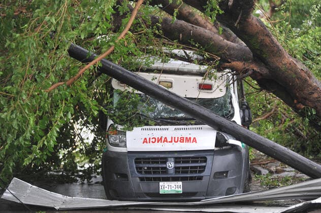 (210822) -- VERACRUZ, Aug. 22, 2021 -- Photo taken on Aug. 21, 2021 shows an ambulance crushed by a tree that fell due to the rain and winds caused by the landfall of Hurricane Grace, in Poza Rica, in the state of Veracruz, Mexico. At least eight people were dead and three missing after Hurricane Grace hit eastern Mexico, Cuitlahuac Garcia, governor of the state of Veracruz, reported on Saturday. (Photo by Xinhua) MEXICO-VERACRUZ-HURRICANE GRACE JesusxAlvarado 