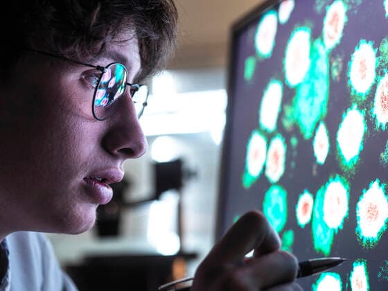 Male scientist researching on biological cell on computer screen in laboratory model released Symbolfoto property released ABRF00910