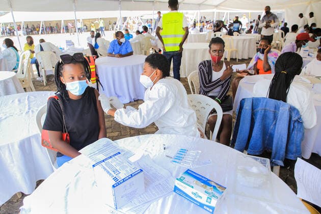(210823) -- KIGALI, Aug. 23, 2021 -- A woman receives the COVID-19 vaccine at a vaccination site in Kigali, Rwanda, on Aug. 23, 2021. Rwanda on Monday started the third phase of mass COVID-19 vaccinations targeting adults 18 years and above in Kigali, the Ministry of Health said. (Photo by Xinhua) RWANDA-KIGALI-COVID-19-VACCINATION CyrilxNdegeya 
