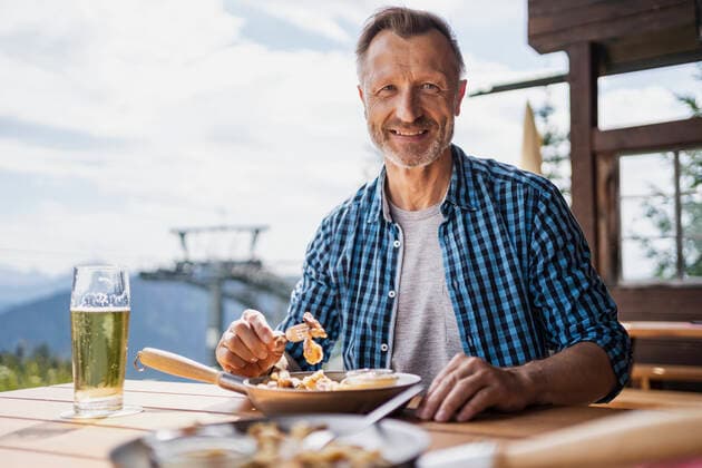 Smiling man having food at restaurant model released Symbolfoto DIGF16314
