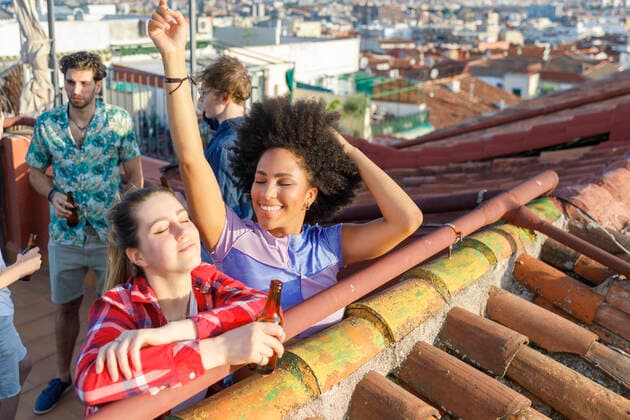 Male and female friends enjoying party on rooftop model released Symbolfoto property released IFRF01042