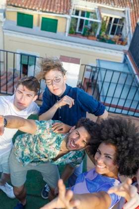 Multi-ethnic male and female friends on rooftop during party model released Symbolfoto property released IFRF01051