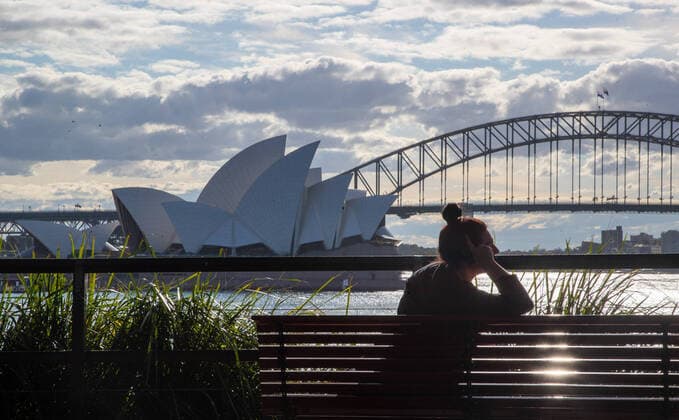 (210826) -- SYDNEY, Aug. 26, 2021 -- A woman is seen near the Sydney Opera House in Sydney, Australia, Aug. 26, 2021. Australia has reported more than 1,000 new COVID-19 cases for the first time since the start of the pandemic. As many as 1,123 new locally-acquired cases of COVID-19 were recorded across Australia on Thursday morning. Despite the record number of infections, Prime Minister Scott Morrison said in Canberra on Thursday that it was another day of hope with the vaccine rollout continuing to accelerate. (Photo by Xinhua) AUSTRALIA-SYDNEY-COVID-19 HuxJingchen 