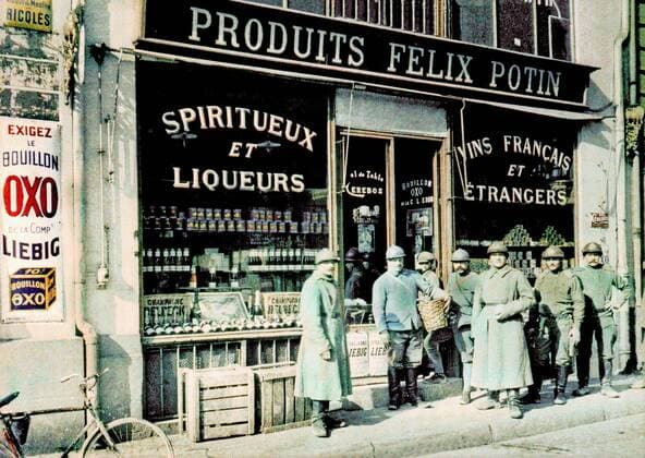 WORLD WAR I IN FRANCE French soldiers in front of the grocery store Felix Potin at the Place des Marchés (Market Square) in Reims. 1917. Liquor and vine are also advertised in the shop windows. Western Front. World War I. Autochrome Lumiere. Photo: Paul Castelnau (1880-1944). France. 19170101 ! ACHTUNG: AUFNAHMEDATUM GESCHÄTZT! *** WELTKRIEG IN FRANKREICH Französische Soldaten vor dem Lebensmittelgeschäft Felix Potin am Place des Marchés Marktplatz in Reims 1917 In den Schaufenstern wird auch für Schnaps und Wein geworben Westfront Erster Weltkrieg Autochrom Lumiere Foto Paul Castelnau 1880 1944 Frankreich 19170101 ACHTUNG AUFNAHMEDATUM GESCHÄTZT