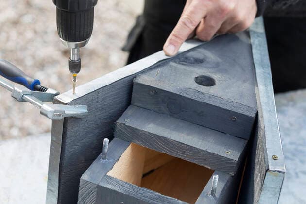 Meisenkasten aus Holz wird selbst gebaut, Metalldach aus Zinkblech wird aufgesetzt und mit den Stirnseiten der Dach-Holzplatten verschraubt, Serienbild 12 16 selfmade wooden tit box, zinc roof is added, series picture 12 16 BLWS651104 *** tit box made of wood is selfmade, zinc roof is added, series picture 12 16 selfmade wooden tit box, zinc roof is added, series picture 12 16 BLWS651104 Copyright: xblickwinkel F.xHeckerx