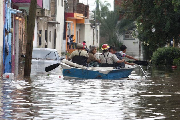 (210904) -- JALISCO, Sept. 4, 2021 -- People row a lifeboat on a street flooded due to heavy rains, in the municipality of Tlaquepaque, State of Jalisco, Mexico, on Sept. 3, 2021. A strong storm during the early hours of Friday caused the El Chicharron and Las Pintas dams to overflow, flooding several areas of the municipality of Tlaquepaque. ) MEXICO-JALISCO-FLOOD ArturoxCampos 