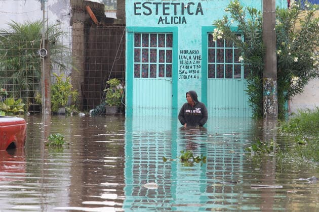 (210904) -- JALISCO, Sept. 4, 2021 -- A person is seen on a street flooded due to heavy rains, in the municipality of Tlaquepaque, State of Jalisco, Mexico, on Sept. 3, 2021. A strong storm during the early hours of Friday caused the El Chicharron and Las Pintas dams to overflow, flooding several areas of the municipality of Tlaquepaque. ) MEXICO-JALISCO-FLOOD ArturoxCampos 