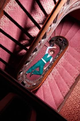 Top view of talented male actor lying on floor near staircase and pretending being dead during creative performance MathiasAlvez_PerformanceInLocation_43.jpg Copyright: xMathiasxAlvezx Model Released