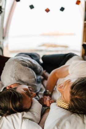 Male friends lying on side at camping van during vacation Sweden, Gothenburg, model released, property released Copyright: xMaskotx , MA88049