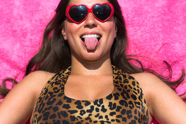 Portrait of young woman sunbathing pulling a face, 28.08.2014, Copyright: xStevexPrezantx, model released, wearing,lying on back,sunbathing,looking at camera,black hair,pink,front view,head and shoulders,leopard skin,portrait,heart shape,at home,fun,humor,confidence,happiness,relaxation,beach towel,20 to 24 years,caucasian ethnicity,female,woman,young woman,only one young woman,one person,outdoors,garden,summer,day,sunglasses,swimwear,swimming costume,making faces,smiling,sticking out tongue,long hair,lifestyle,sunlight,leisure,vacation,only female,September 2014 Release,Reclining,Lying On Back,Sunbathing,Caucasian Ethnicity,Young Adult,20-24 Years,Female,Women,Young Women,Young Adult Woman,Confidence,Enjoyment,Fun,Humor,Relaxation,Wellb Ref:IS09AK7XU