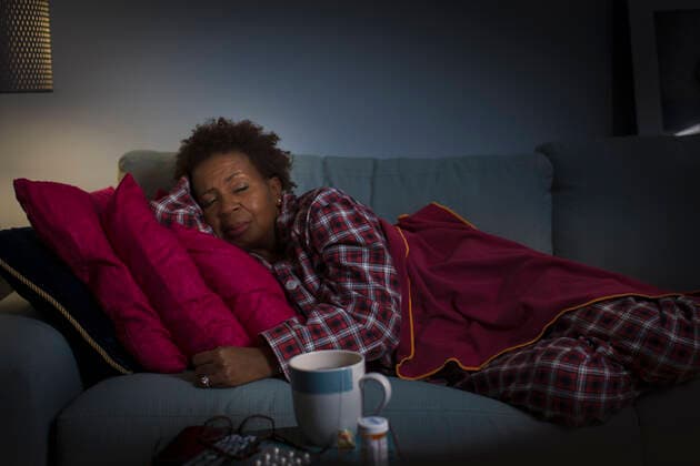 IMAGO Creative, Winter, Couching Mature woman with cold lying on couch, 12.01.2015, Copyright: xStevexPrezantx, model released, sleeping,wearing,lying down,lying on side,resting,red,differential focus,checker pattern,at home,sofa,blanket,cushion,cup,50 to 54 years,female,woman,mature woman,only one mature woman,one person,house interior,indoors,living room,pyjamas,eyes closed,afro,illness,medicine,recovering,african ethnicity,cold and flu,healthcare,January 2015 Release,Gesturing,Eyes Closed,Reclining,Lying On Side,Resting,Sleeping,African Descent,Mature Adult,50-54 Years,Female,Women,Recovery,Unwell,Illness,Cold And Flu,Red,Afro,One Person,Pattern,Checker Pattern,Selective Focus,Medicine,Medicines,Cup,Soft Furnishing,Bedding,Blanket,Cushion,Furniture,Seat,Sofa,Sleepwea Ref:IS09AN6UM