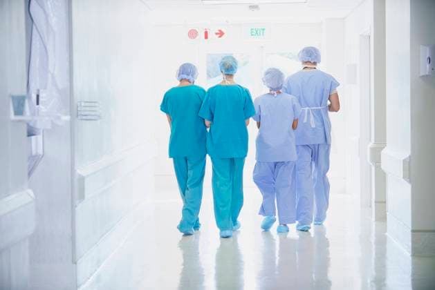 Rear view of four medical staff wearing scrubs walking in hospital corridor, 15.09.2016, Copyright: xFrankxandxHelenax, model released, wearing,walking,working,blue,white color,rear view,preparation,responsibility,cooperation,skill,teamwork,caucasian ethnicity,mixed race ethnicity,multi-ethnic group,woman,mid adult woman,young woman,man,mid adult man,senior man,four people,medical occupation,nurse,corridor,indoors,south africa,hospital,surgical cap,medical clothing,surgical scrubs,protective clothing,medicine,both male and female,health-and-safety,paarl,healthcare,September 2016 Release,Walking,Working,Caucasian Ethnicity,Mixed Race Person,Multi-Ethnic Group,Female,Women,Young Women,Mid Adult Women,Male,Men,Mid Adult Men,Senior Men,Nurse Ref:IS09B23W5