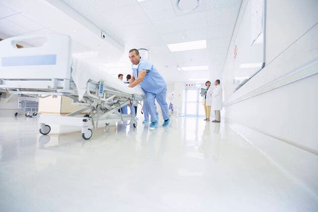 Medics urgently pushing hospital bed along corridor, 15.09.2016, Copyright: xFrankxandxHelenax, model released, wearing,pushing,working,white color,full length,low angle view,concentration,responsibility,serious,urgency,cooperation,efficiency,skill,teamwork,on the go,caucasian ethnicity,mixed race ethnicity,multi-ethnic group,woman,mature woman,young woman,man,mid adult man,young man,five people,medical occupation,nurse,people in the background,corridor,indoors,south africa,hospital,action,medical clothing,surgical scrubs,protective clothing,medicine,speed,hospital bed,moving,patient,emergency,both male and female,health-and-safety,paarl,healthcare,coordinate,en route,September 2016 Release,Pushing,Thinking,Concentration,Working,Caucasia Ref:IS09B23X0