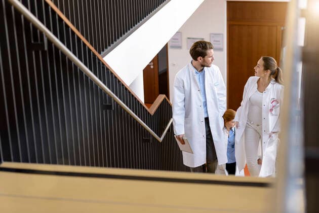 Male and female doctors moving up hospital stairway, talking, 18.01.2017, Copyright: xsuedhangx, model released, wearing,discussing,planning,working,front view,three quarter length,organization,responsibility,cooperation,skill,teamwork,on the go,20 to 24 years,caucasian ethnicity,woman,young woman,man,young man,colleague,three people,medical occupation,doctor,people in the background,stairway,indoors,hospital,lab coat,medicine,moving upwards,both male and female,Star Images,healthcare,update,junior doctor,January 2017 Release,Conversation,Working,Caucasian Ethnicity,Young Adult,20-24 Years,Female,Women,Young Women,Young Adult Woman,Male,Men,Young Men,Healthcare Occupation,Physician,Businesspeople,Incidental People,People In The Backgroun Ref:IS09B417B