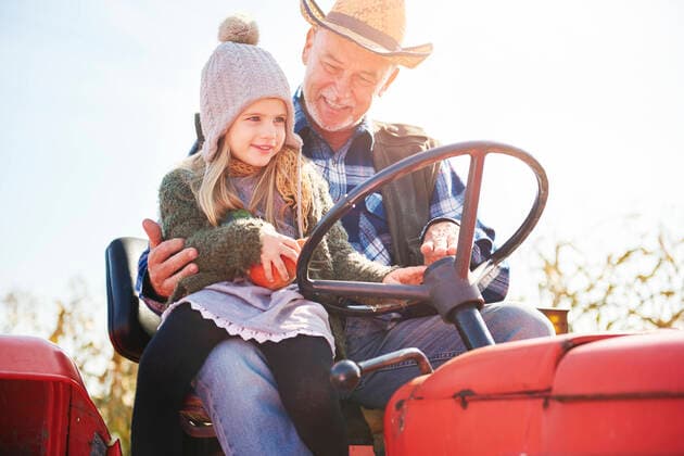 Farmer and granddaughter at pumpkin farm, 16.10.2017, Copyright: xGpointstudiox, model released, farming,wearing,looking down,riding,focus on foreground,low angle view,childhood,active seniors,bonding,festive,quality time,togetherness,shyness,happiness,tractor,60 to 64 years,child,3 to 4 years,toddler,female,girl,male,man,senior man,two people,farmer,outdoors,farm,autumn,day,agriculture,cowboy hat,beanie hat,halloween,sitting,sitting on lap,smiling,family,three generation family,granddaughter,grandfather,pumpkin,sunlight,family business,both male and female,holiday season,October 2017 Release,Riding,Sitting,Lap,Looking Down,Senior Adult,60-64 Years,Child,Toddler,Female,Girls,Girl,Male,Men,Senior Men,Family,Grandparent,Grandfather,Multi-G Ref:IS09B8X8D