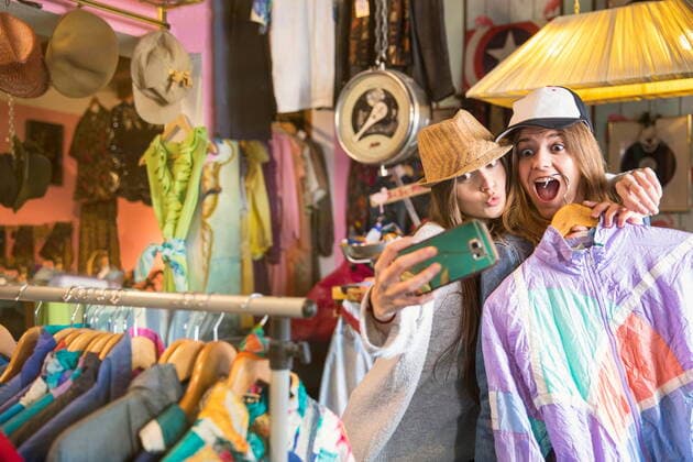 Friends taking selfie in thrift store, 23.04.2018, Copyright: xRUSSxROHDEx, model released, buying,shopping,waist up,mischief,retro,style,sharing,togetherness,confidence,friendship,happiness,vintage,clothes rail,20 to 24 years,teenager,18 to 19 years,caucasian ethnicity,female,girl,young woman,two people,indoors,retail structures,shop,clothes shop,day,clothing,fashion,selfie,technology,cellular telephone,lifestyle,youth culture,Star Images,smartphone,thrift store,second hand,digital native,April 2018 Release,Photographing,Buying,Shopping,Caucasian Ethnicity,Young Adult,18-19 Years,20-24 Years,Teenager,Female,Women,Young Women,Young Adult Woman,Girls,Girl,Confidence,Mischief,Relationship,Friendship,Sharing,Style,Togetherness,Wellbeing,Hap Ref:IS09BD3HC