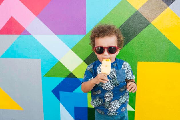 IMAGO Creative: NGO, Kunst im öffentlichen Raum und Kulturinitiativen Toddler eating ice cream, mural in background, Wynwood, Miami, Florida, USA, 03.09.2018, Copyright: xLindsayxUpsonx, model released, eating,wearing,holding,background,abstract,portrait,waist up,triangle,beginnings,childhood,cool,discovery,fun,innocence,confidence,child,toddler,only one toddler,curly hair,hispanic ethnicity,male,boy,only one boy,one person,united states of america,florida,miami,outdoors,summer,day,art,mural,sunglasses,t-shirt,standing,ice cream,ice lolly,sunlight,vacation,youth culture,1 to 2 years,hip,enjoyment,patterned background,multicolour,September 2018 Release,wynwood,Consuming Food,Eating,Standing,Holding,Child,Toddler,1-2 Years,Male,Boys,Beginnings,Childhood,Confidence,Cool,Curiosity,Enjoyment,Fun,Innocence,Curly Ref:IS09BN3IL