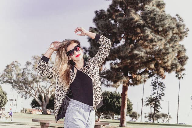 Hip young woman dancing in park, 08.10.2018, Copyright: xAshleyxCorbin-Teichx, model released, wearing,dancing,looking at camera,focus on foreground,low angle view,motion,leopard skin,portrait,three quarter length,girl power,cool,carefree,freedom,happiness,tree,25 to 29 years,caucasian ethnicity,female,woman,young woman,only one young woman,one person,united states of america,california,outdoors,park,day,casual clothing,sunglasses,fashion,jacket,hands raised,smiling,sunlight,leisure,youth culture,long beach,hip,hipster,hands open,November 2018 Release,Gesturing,Hand Raised,Physical Activity,Dancing,Caucasian Ethnicity,Young Adult,25-29 Years,Female,Women,Young Women,Young Adult Woman,Carefree,Cool,Freedom,Motion,Girl Power,Wellbeing,Happ Ref:IS09BP5C5