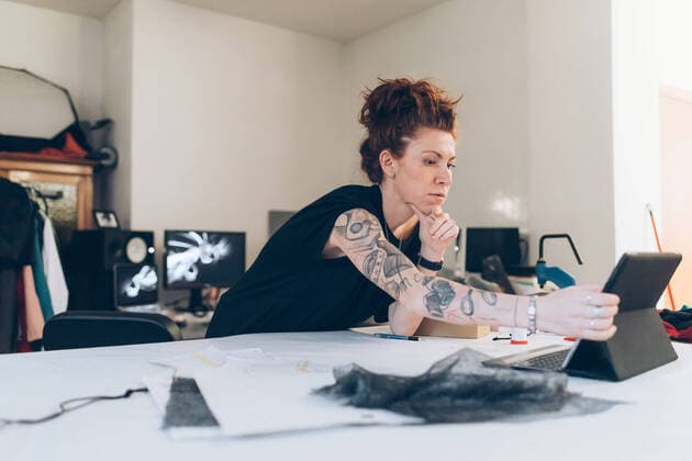 Fashion designer researching using digital tablet, 04.12.2018, Copyright: xEugenioxMarongiux, model released, , property released, learning,looking down,sewing,working,red hair,differential focus,waist up,making money,small business,craft,precision,real people,creativity,guidance,independence,passion,skill,internet,workbench,30 to 34 years,caucasian ethnicity,female,woman,mid adult woman,only one mid adult woman,one person,occupation,fashion designer,seamstress,tattoo,indoors,workshop,fashion,hair back,technology,digital tablet,textiles,artisan,bending forward,design studio,dressmaker,fashion industry,reference,small business owner,craftswoman,touch screen,researching,using digital tablet,arms reaching out,made to measure,December 2018 Re Ref:IS09BT7A8