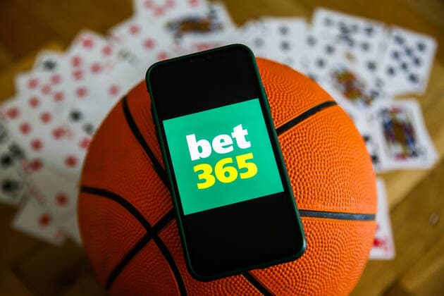 Online Gambling Companies Photo Illustrations Bet 365 logo displayed on a mobile phone, basketball and playing cards are seen in this illustration photo taken in Krakow, Poland on September 21, 2021. Krakow Poland porzycki-onlinega210921_npcjg  Copyright: xJakubxPorzyckix