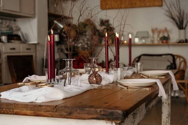 White tablecloth and plates placed on festive table decorated with burning candles and dry branches of tree, Property released GustavoPozo_ChristmasDecoration_66.jpg Copyright: xGustavoxPozox Model Released