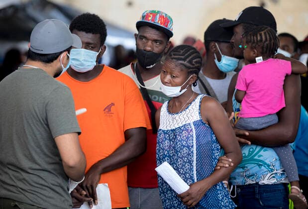 (210925) -- CIUDAD ACUNA (MEXICO), Sept. 25, 2021 -- Haitian migrants speak to a Mexican immigration official at a shelter in Ciudad Acuna, Mexico, on Sept. 25, 2021. U.S.-Mexico border arrests have reportedly stayed at the highest level in more than two decades, with more than 208,000 registered in August alone. (Photo by Xinhua) MEXICO-CIUDAD ACUNA-U.S.-BORDER-MIGRANTS NickxWagner 
