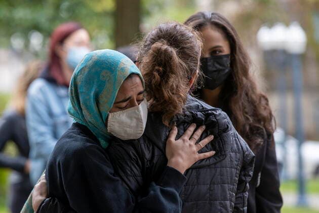 September 27, 2021, Kingston, on, Canada: Meena Waseem from the Sexual Assault Centre of Kingston, hugs a sexual assault victim after she spoke to Queen s University student who organize a walkout to protest sexual assault on campuses and in and in support of the victims of sexual assault at Western University, in Kingston, Ont.,, on Monday Sep. 27, 2021. Kingston Canada  - ZUMAc35_ 20210927_zaf_c35_028 Copyright: xLarsxHagbergx