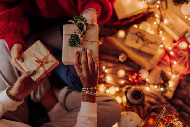 Female friends giving gifts to each other during Christmas model released Symbolfoto property released EGHF00178