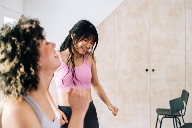 Female friends exercising together at home model released Symbolfoto property released ASGF01131