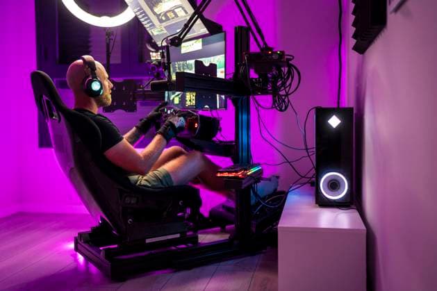 Man playing video game while sitting on chair at studio model released Symbolfoto property released DLTSF02112