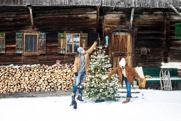 Young couple decorating Christmas tree during winter model released Symbolfoto property released HHF05660