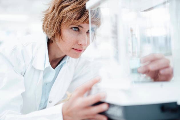 Female pharmacist looking at medical equipment in glass box model released Symbolfoto property released JOSEF05401