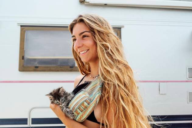 Smiling young woman with kitten in waist pack model released Symbolfoto property released PGF00760