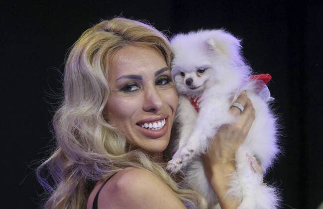 MOSCOW, RUSSIA â€“ SEPTEMBER 28, 2021: A dog with its owner at a ceremony to present the 2021 Golden Pet Awards at the Federation Tower of the Moscow International Business Centre. Vladimir Gerdo TASS  TS11259B
