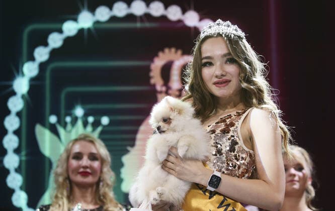 MOSCOW, RUSSIA â€“ SEPTEMBER 28, 2021: A dog with its owner at a ceremony to present the 2021 Golden Pet Awards at the Federation Tower of the Moscow International Business Centre. Vladimir Gerdo TASS  TS1125B1