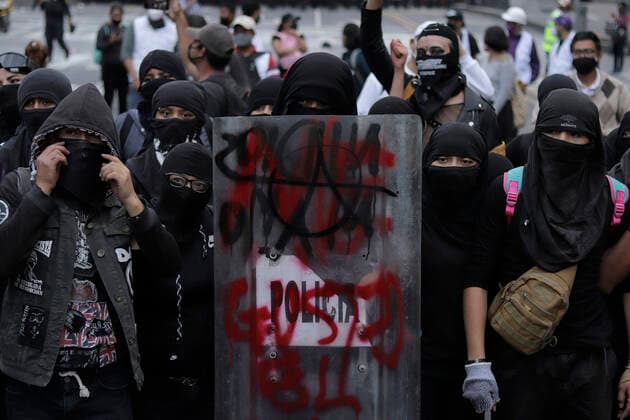 53rd Anniversary Of The Massacre Of Tlatelolco, Mexico Members of the Black Bloc hold the shield of a policeman as they march on Eje Central in Mexico City towards the Zocalo of the capital to mark the 53rd anniversary of the Tlatelolco Massacre that took place on 2 October 1968 in the square. Mexico City Mexico vieyra-notitle211002_npm1f  Copyright: xGerardoxVieyrax