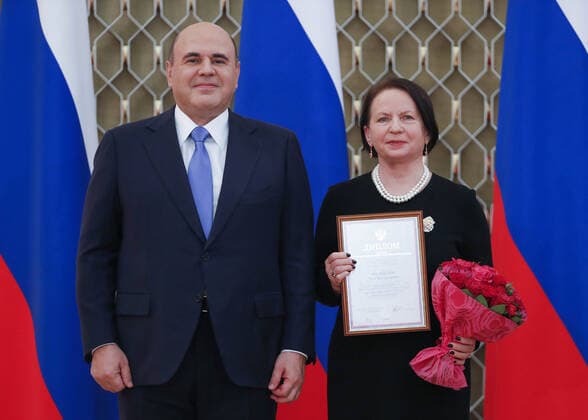 MOSCOW, RUSSIA - OCTOBER 5, 2021: Russia s Prime Minister Mikhail Mishustin (L) poses with St Petersburg University professor Nina Bordovskaya during a ceremony to award commendations and state prizes in the field of education and mark Teachers Day. Dmitry Astakhov POOL TASS  TS11321C