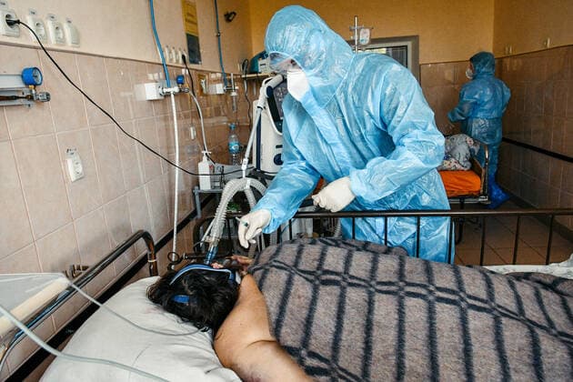 ZAPORIZHZHIA, UKRAINE - OCTOBER 07, 2021 - A medical worker in protective gear tends to a patient on the premises of the Regional Infectious Diseases Clinical Hospital of the Zaporizhzhia Regional Council where 99 per cent of coronavirus beds are currently occupied, Zaporizhzhia, southeastern Ukraine  Copyright: xDmytroxSmoliyenkox