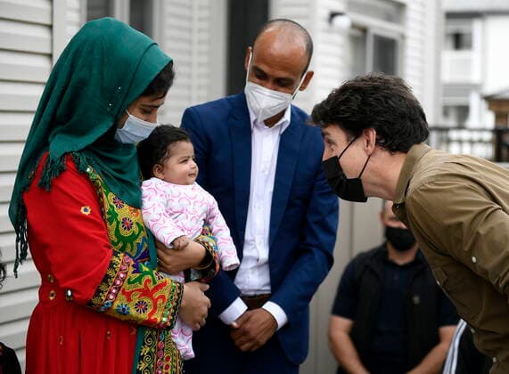 October 9, 2021, Ottawa, on, Canada: Prime Minister Justin Trudeau gets a smile from Hawa Rahimi, 2 months, as he meets her parents, Obaidullah, right and Arezoo, left, in Ottawa, on Saturday, Oct. 9, 2021. Obaidullah Rahimi worked at the Canadian Embassy in Afghanistan; his family is one of 22 recently resettled Afghan families in the Ottawa area. Ottawa Canada - ZUMAc35_ 20211009_zaf_c35_003 Copyright: xJustinxTangx