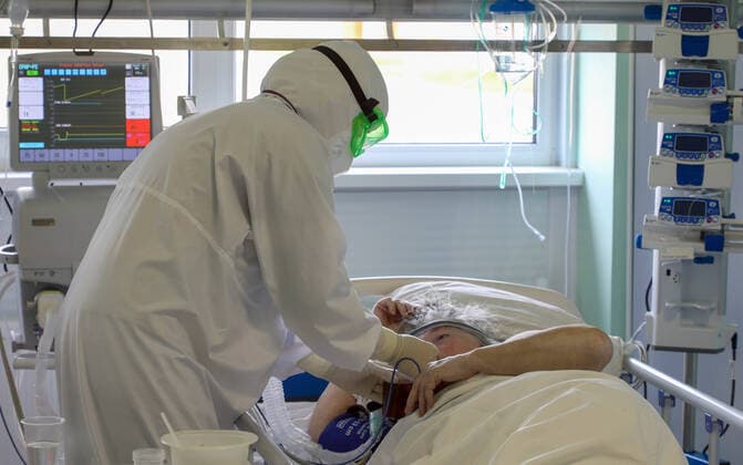 VOLGOGRAD REGION, RUSSIA â€“ OCTOBER 12, 2021: A healthcare worker checks on a patient in an intensive care unit at the Kalachevskaya Central District Hospital treating people who suffer from the novel coronavirus disease (COVID-19). On October 12, Russia s Healthcare Minister Mikhail Murashko said that over 6 thousand patients with COVID-19 in Russia were on ventilators; right now around 255 thousand hospital beds for COVID-19 patients have been set up in Russia, which is 11% more than a week earlier. Dmitry Rogulin TASS  TS113E12